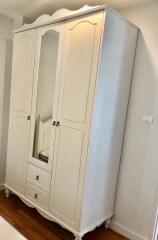 Large white wardrobe in a bedroom