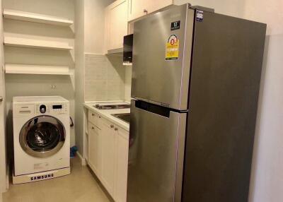 Compact kitchen with appliances and laundry area