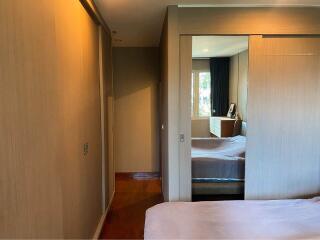 Master bedroom with large mirrored closet and attached sitting area