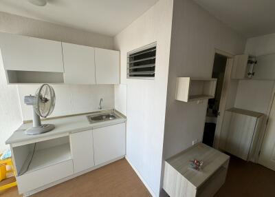 Small kitchen with white cabinets and minimalistic design