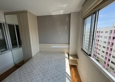 Bedroom with large window and built-in wardrobe