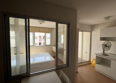 Bedroom and adjacent space with windows and natural light