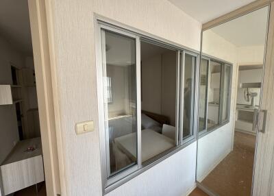 bedroom seen from corridor with glass window partition