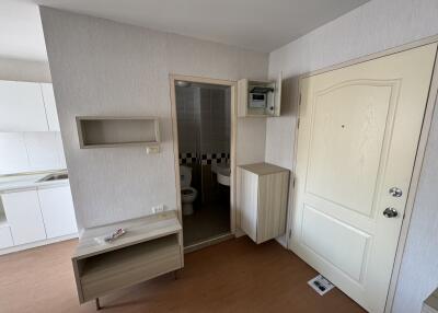 Studio apartment with view of kitchen, bathroom, and entry door