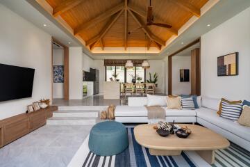 Spacious and modern living room with wooden ceiling and contemporary decor