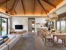 Spacious living room with wooden ceiling, open kitchen, and dining area