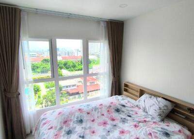 Cozy bedroom with large window and floral bedding