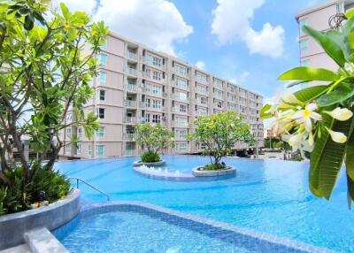 Resort-style swimming pool with surrounding greenery