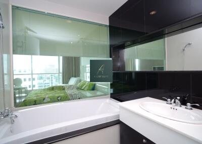 Modern bathroom with a view into a bedroom