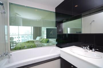 Modern bathroom with a view into a bedroom