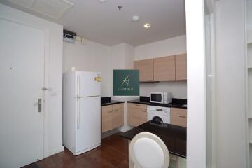 Modern kitchen with light wood cabinets and appliances