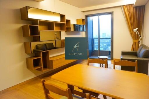 Modern living room with wooden dining table and wall-mounted shelving