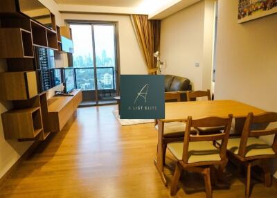 Modern living room and dining area with wall-mounted TV and city view