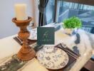 Elegant dining setup with candle holder and greenery