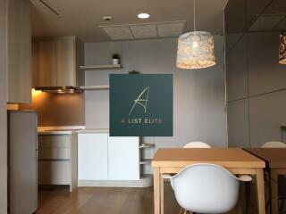 Modern kitchen and dining area with light fixtures and built-in cabinets