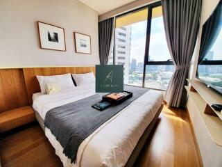 Modern bedroom with large window and city view