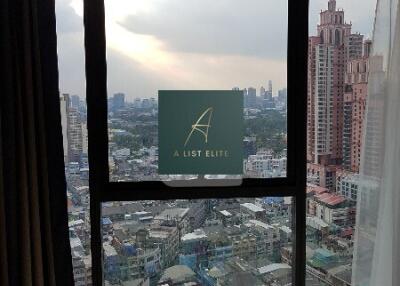 Bedroom with a large window offering a city view