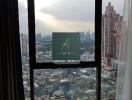 Bedroom with a large window offering a city view