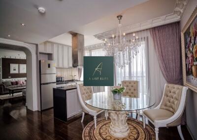 Elegant dining area with glass table and chandelier