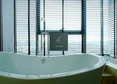 Modern bathroom with large freestanding bathtub and panoramic city view