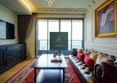 Stylish living room with large window, leather sofa, and a TV.