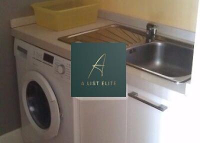 Small laundry room with a washing machine and sink