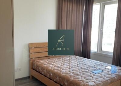 Bedroom with wooden bedframe and large window