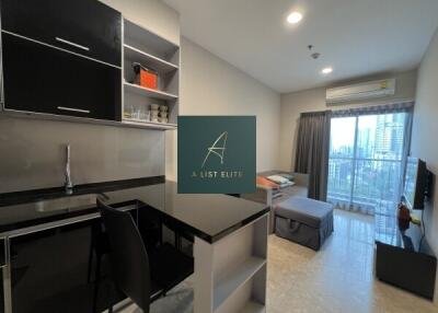 A modern studio apartment with an open kitchen and living area