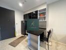 Modern kitchen with black cabinetry and a small bar