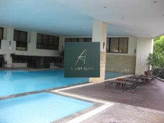 Indoor swimming pool area with lounge chairs