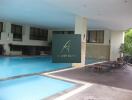 Indoor swimming pool area with lounge chairs