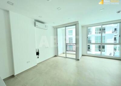 Spacious living room with large windows and balcony access