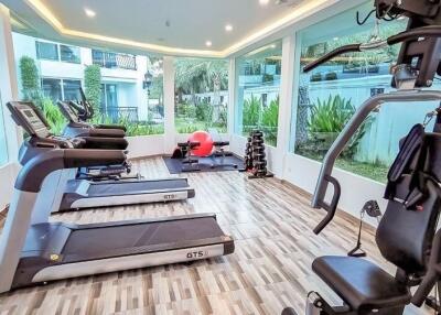 Well-equipped modern gym with large windows