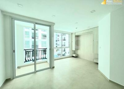 Bright and spacious living room with large windows and balcony access