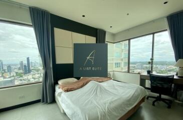 Bedroom with large windows and city view