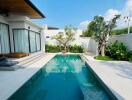 Modern backyard pool area with greenery