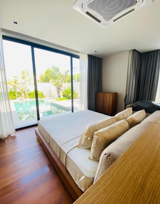 Spacious bedroom with a view of the pool