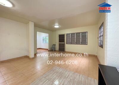 Spacious living room with tiled flooring and large windows