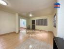 Spacious living room with tiled flooring and large windows