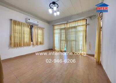 spacious living room with large windows and curtains