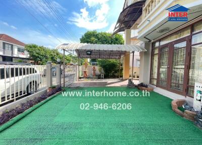 Outdoor area of a building with a garden and covered patio