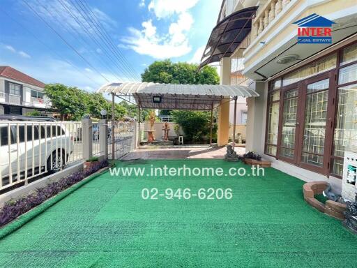 Outdoor area of a building with a garden and covered patio