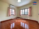 Empty bedroom with tiled floor, curtains, and air conditioning unit.