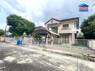 Front view of a two-story house with a gated yard