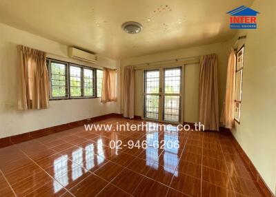 spacious bedroom with large windows and tiled floor