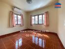 Empty bedroom with two windows and air conditioning unit