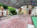 Covered driveway with garden and small shrines