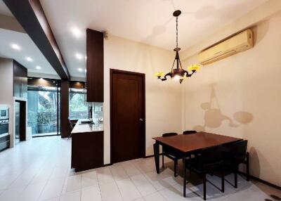 Modern kitchen and dining area with table, chairs, and built-in appliances