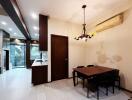 Modern kitchen and dining area with table, chairs, and built-in appliances