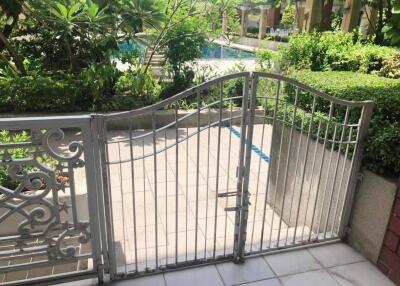 Outdoor area with pool view and metal gate